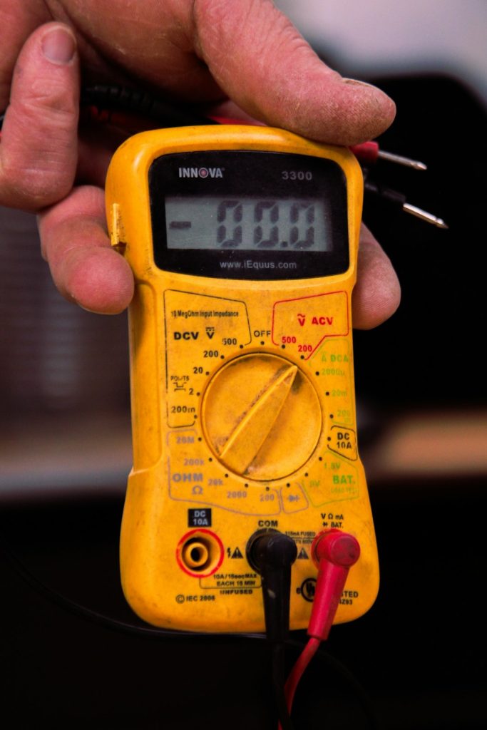 a-person-holding-a-multimeter-in-their-hand-gnbjjyh0cz4