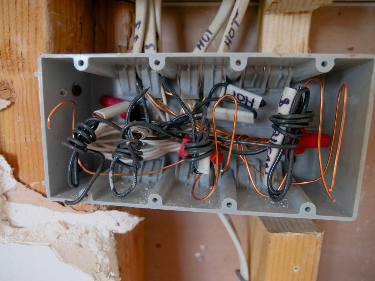 Crafting Captivating Headlines: Your awesome post title goes here Detailed view of an open electrical switchboard with tangled wires and cables.